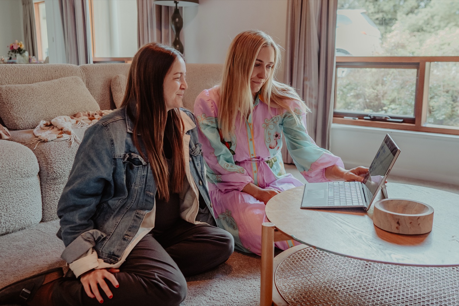 Marley sitting with a client on the living-room floor during an in-home birth education session