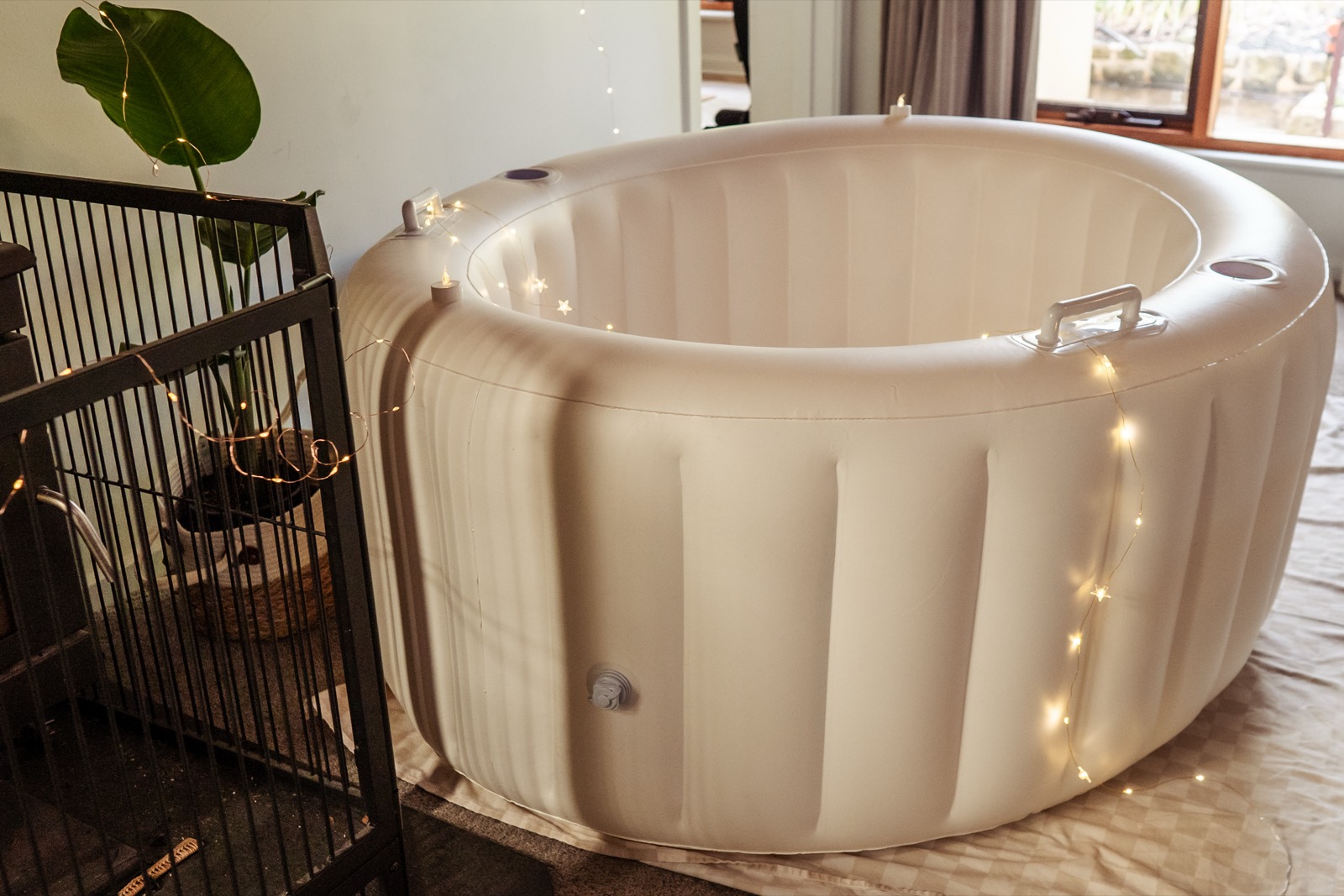 White birth pool set up in a cosy room with fairy lights